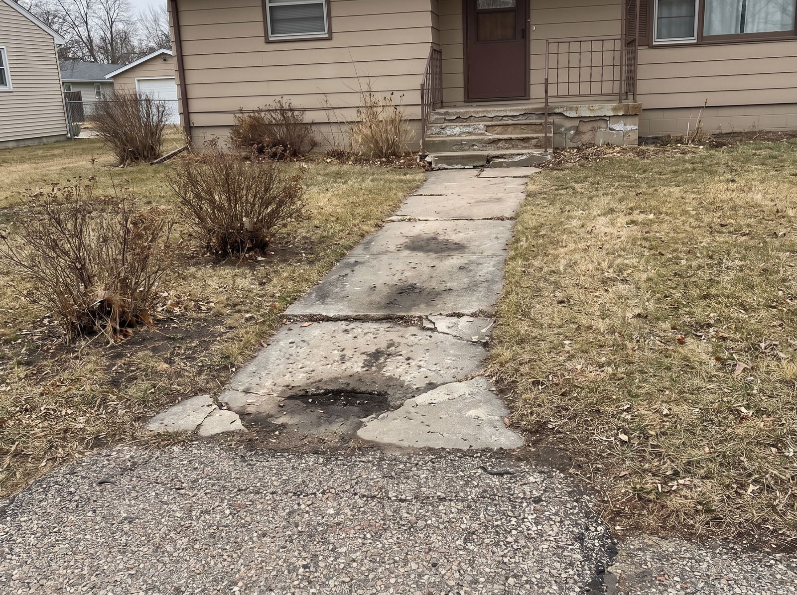 Cracked concrete walkway before replacement, Harrisburg, SD